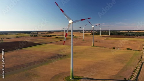 A large number of wind turbines generate electricity near the city at sunset. A classic source of alternative energy