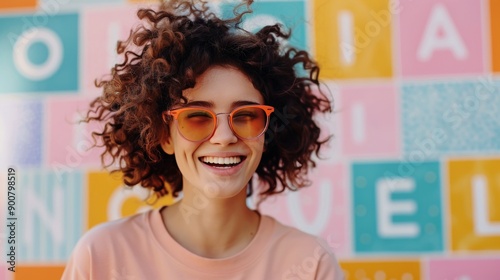 Woman Smiling In Sunglasses Against Colorful Wall