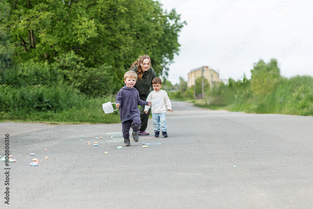 Mother with Two Kids Playing Outdoors Mother with Two Kids Playing Outdoors