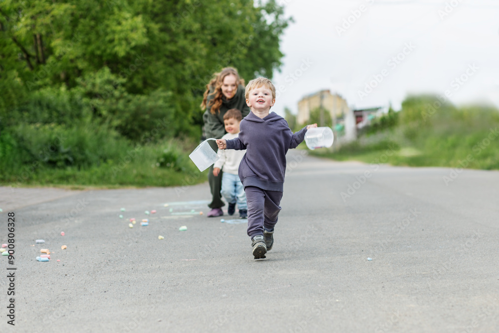 Fototapeta premium Happy Child Running with Containers Outdoors