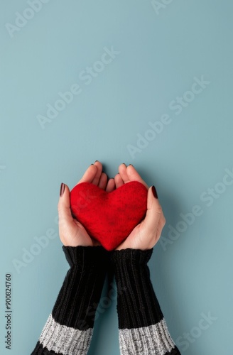 Hands Holding Red Heart on Blue Background