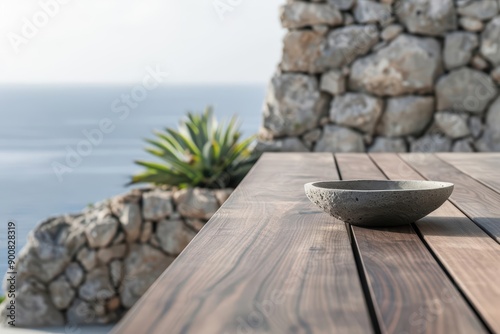 A chic modern style wood table set against coastal cliffs