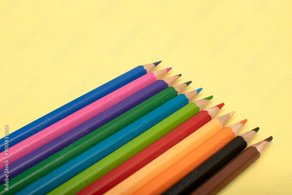 Colored pencils on yellow background Colored pencils on yellow background