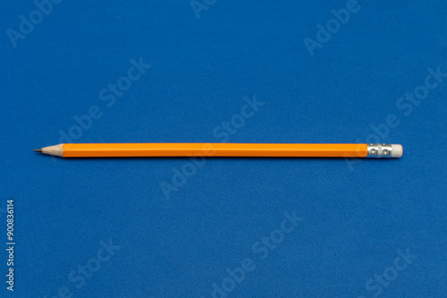 A pencil on blue background photo