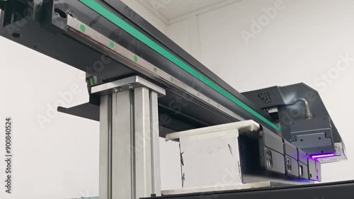 A modern digital large-format UV printer prints images on smartphone cases. UV pinning is the process of applying a dose of low intensity ultraviolet light to a UV curable ink