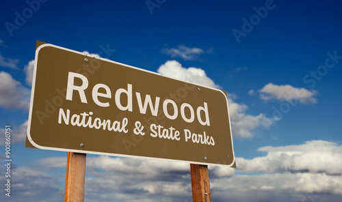 Redwood National and State Parks (California) Road Sign Against Blue Sky and Clouds.