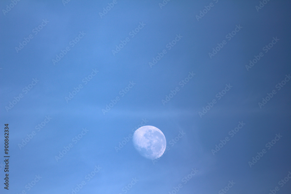 moon over blue. moon in the sky. moon appearing during the day. moon over blue. moon in the sky. moon appearing during the day.