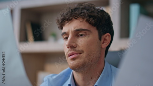 Worried businessman analysing papers in office closeup. Concerned man reading