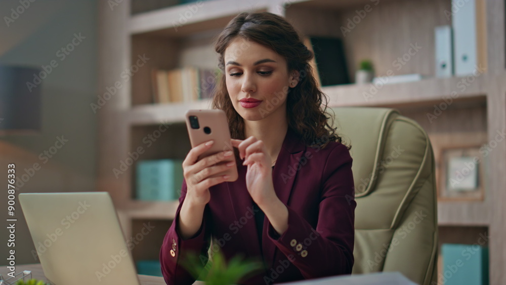 Relaxed businesswoman scrolling cellphone at office buro. Stylish worker texting Relaxed businesswoman scrolling cellphone at office buro. Stylish worker texting
