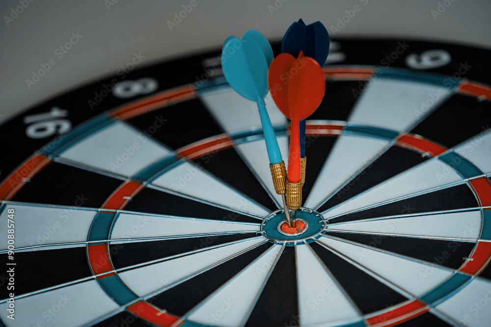 Concept of challenge in business marketing bullseye and intelligent customer reaching. The dart is the strategy or skill. The dartboard is the target or goal. uds