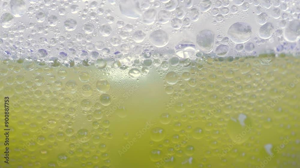 Drops of ice on a green tea glass