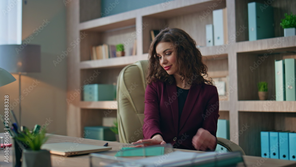 Smiling manager opening computer in modern office. Relaxed woman starting work Smiling manager opening computer in modern office. Relaxed woman starting work