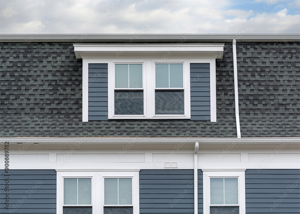 close-up view of the upper portion of a residential building with dormer in Brighton, Massachusetts, USA close-up view of the upper portion of a residential building with dormer in Brighton, Massachusetts, USA