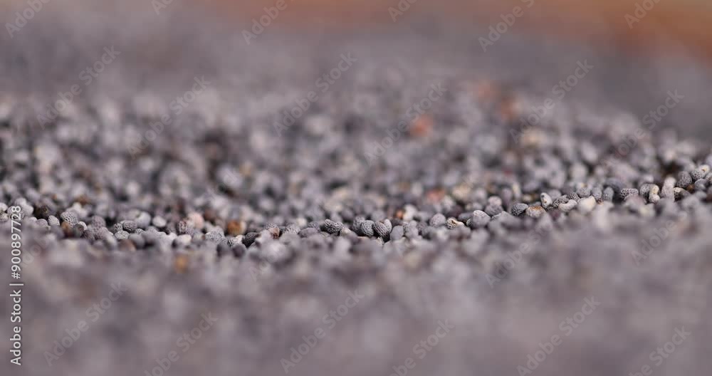 poppy seeds that are used in cooking, poppy seeds in a wooden round bowl on the table poppy seeds that are used in cooking, poppy seeds in a wooden round bowl on the table