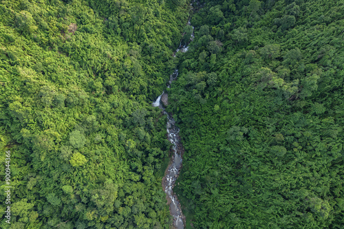 Beautiful aerial top view natural scenery of river in Southeast Asia tropical green forest with mountains in background.