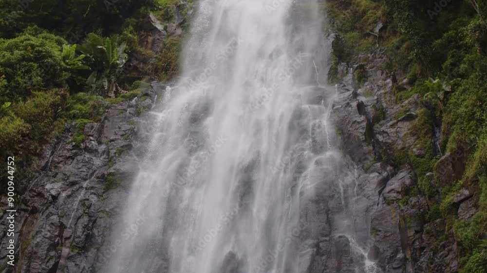 Materuni Waterfall cascades down lush green cliffs in Moshi town, Tanzania, creating a serene scene Materuni Waterfall cascades down lush green cliffs in Moshi town, Tanzania, creating a serene scene