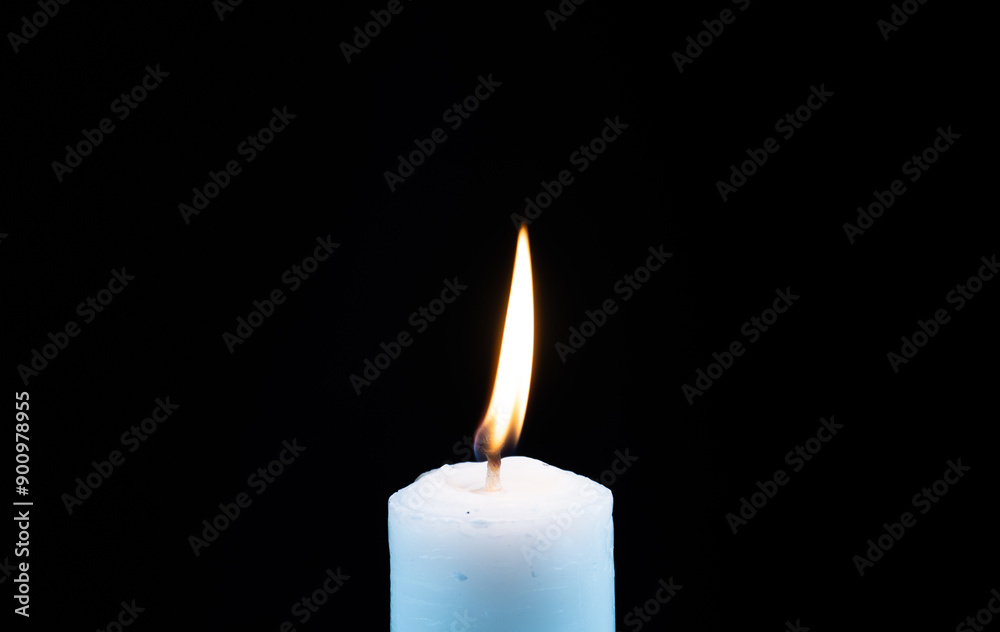 candle lit with curved flame isolated black background