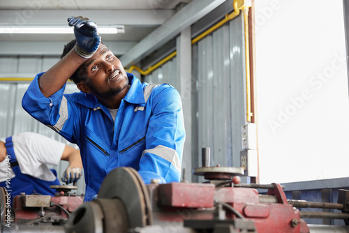 workers or technicians feeling tired from hot weather over heat in the factory