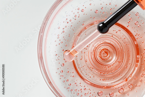 Closeup of Transparent Serum Droplet with Beauty Pipette on White Background - Top-Down View photo