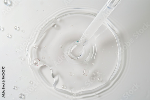 Clear Beauty Serum Spill with Pipette on Pure White Background - Close-Up Perspective photo