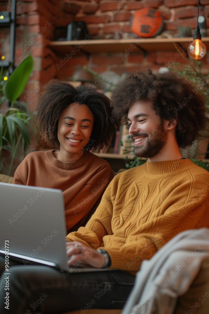 Multiracial couple enjoying quality time together using laptop on home sofa Multiracial couple enjoying quality time together using laptop on home sofa