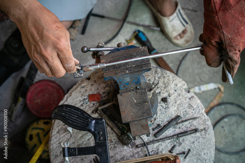 Man hand Industrial worker welding metal at factory workshop