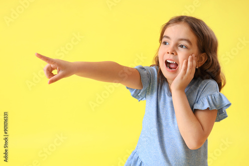 Shocked little girl pointin...