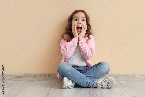 Shocked little girl sitting...