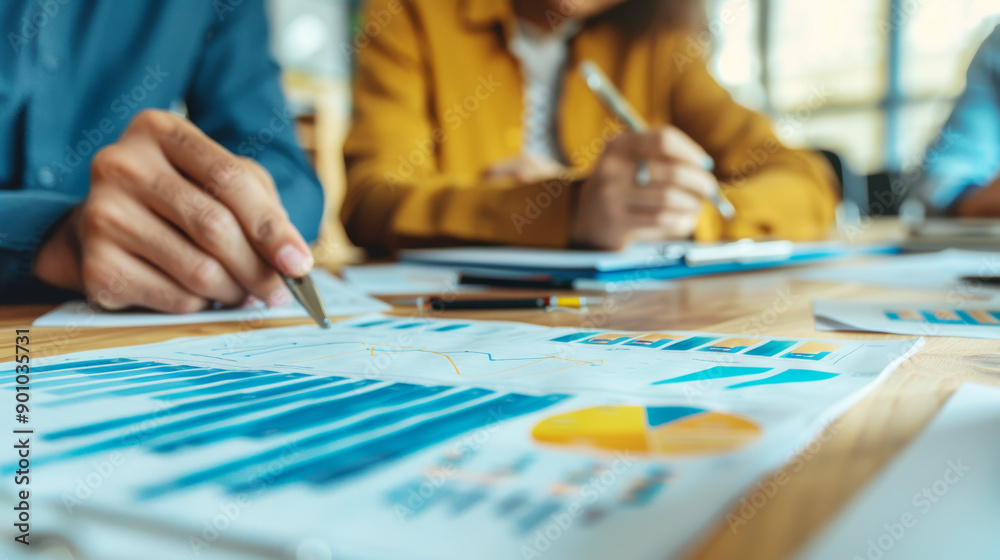 Business Team Analyzing Financial Data and Graphs in a Meeting Room for Strategic Planning and Decision Making Business Team Analyzing Financial Data and Graphs in a Meeting Room for Strategic Planning and Decision Making
