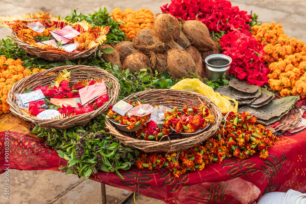 India, Uttar Pradesh, Varanasi, Bangali Tola. Flowers, coconuts, and other offerings.