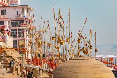 India, Uttar Pradesh, Varanasi, Ghasi Tola. Poles and baskets near Panchganga Ghat. In the evening lamps in the baskets are lit for departed souls. photo