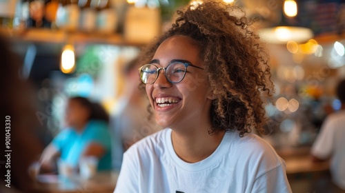 Joyful Interaction: A Young Woman Laughing in a Lively Indoor Setting, Surrounded by Friends in a Casual, Social Atmosphere