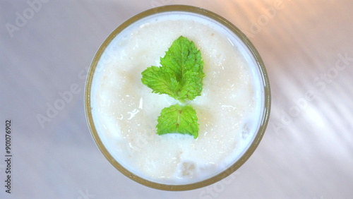 Refreshing mint smoothie in glass, view from above, garnished with fresh mint leaves, showcasing healthy and delicious drink option for nutritious diet. Healthy Eating and Lifestyle.