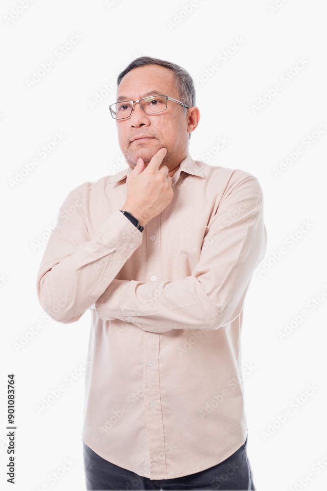 Asia man in glasses is looking down and thinking. He is wearing a white shirt and black pants Asia man in glasses is looking down and thinking. He is wearing a white shirt and black pants