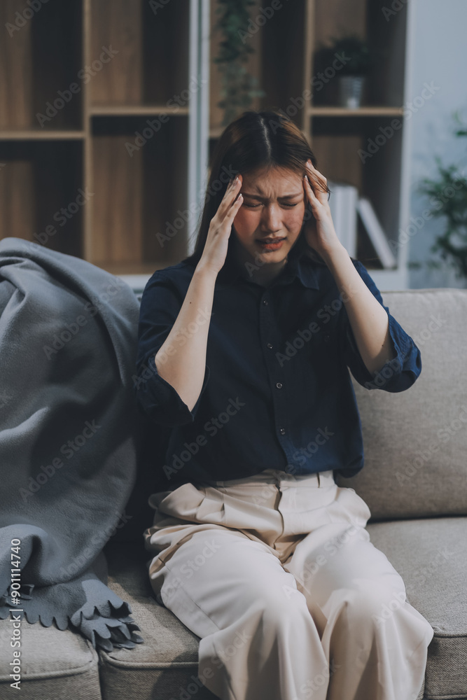 A woman with a cold with pills is treated at home chooses which drugs to take and self-medicates, checks the expiration date while sitting on the couch at home