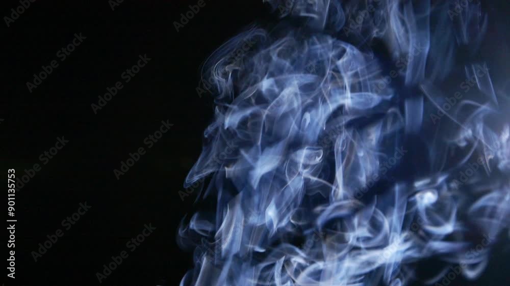 Abstract blue clouds of smoke, fog, steam, mist texture on black in slow motion Abstract blue clouds of smoke, fog, steam, mist texture on black in slow motion