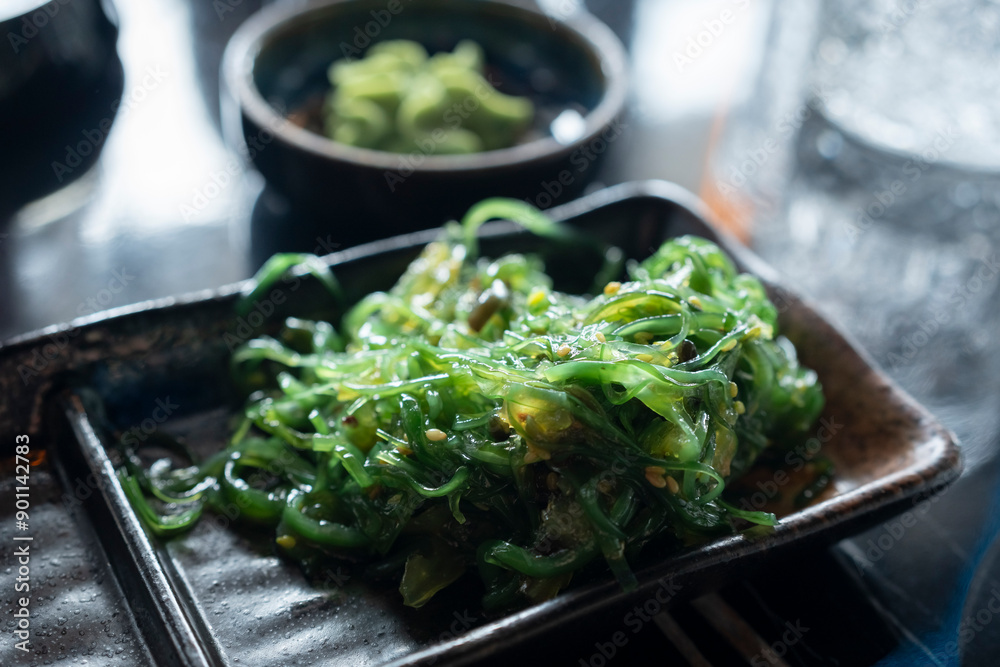 Wonderful view of a bowl of Wakame seaweed salad, typical dish in East Asia. Wonderful view of a bowl of Wakame seaweed salad, typical dish in East Asia.