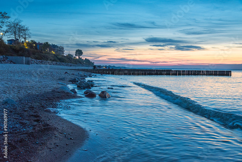 View of sand beach with wooden breakwaters on the Baltic Sea coast on sunset in Zelenogradsk. Russia