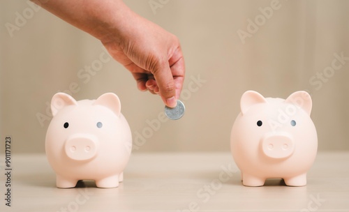 Obraz na płótnie hand putting coins in pink piggy bank, Investment Selection Planning step up, saving money for future plan, retirement fund, budget, investment, finance concept. w salonie