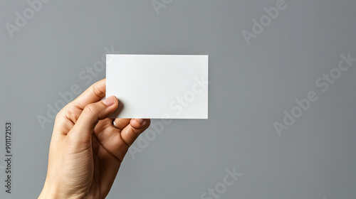 Hand Holding Card: Illustrates a hand holding a card isolated on a background.