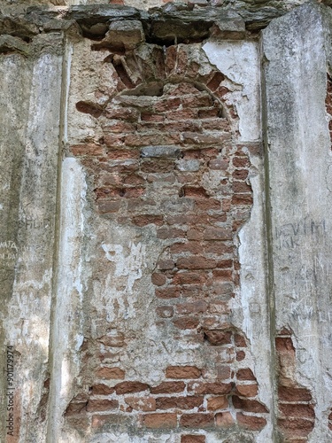 patterns of red bricks of and old abandoned church tower wall.Medieval gothic church reamins in central Europe photo