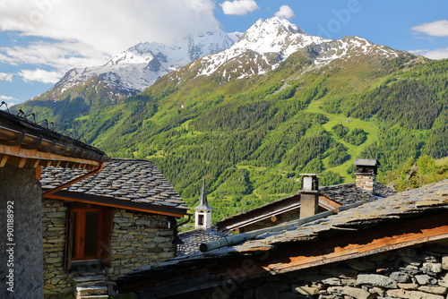 Obraz na płótnie The well preserved hamlet Le Chatelard and its traditional houses, Montvalezan, Northern French Alps, Tarentaise, Savoie, France, with the two summits Mont Pourri and Aiguille rouge in the background w salonie