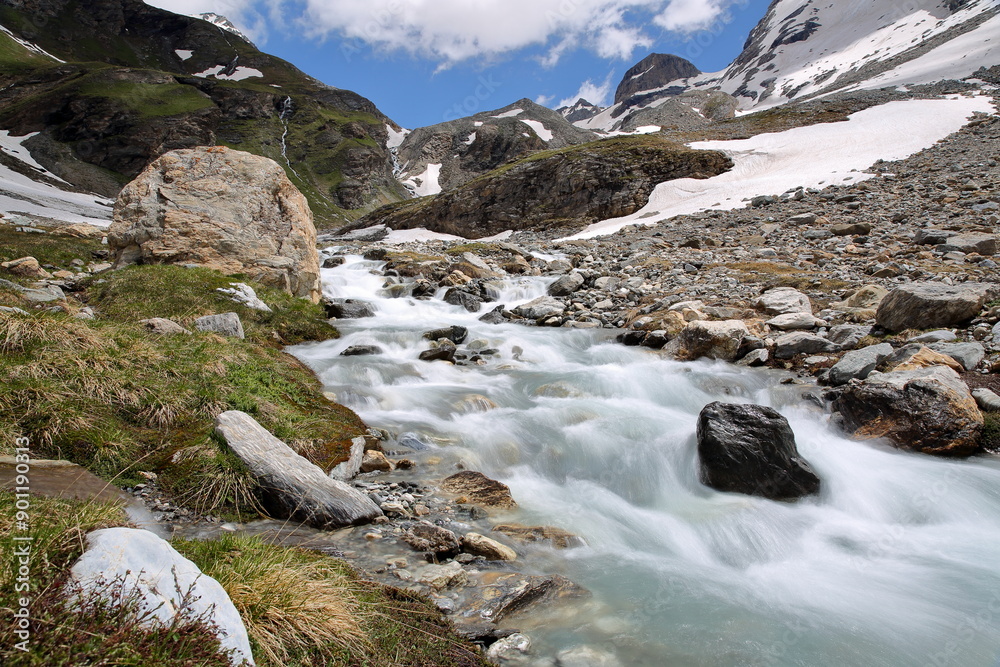 A mountain stream located along a hiking trail leading to Rhemes Golette glacier, at the bottom of Sassiere valley (Grande Sassiere natural reserve), Tignes, Northern French Alps, Savoie, France
