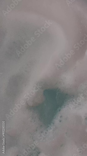 Vertical close-up of foam in a jacuzzi. High quality 4k footage