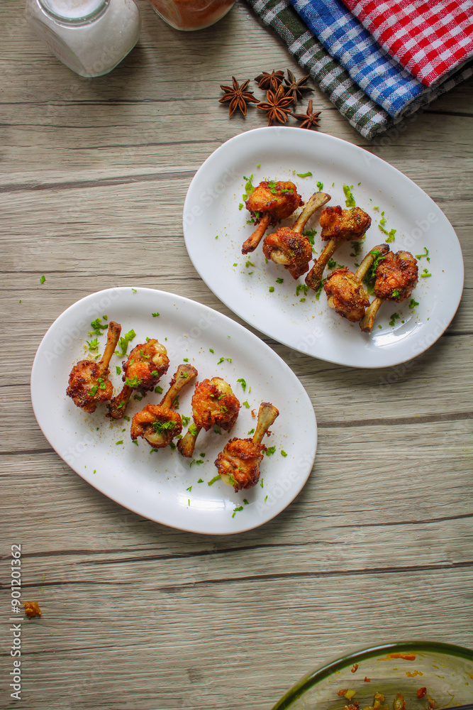 Chicken lollipop deep fried in oil. Later garnished with green coriander and onion. Chicken lollipop deep fried in oil. Later garnished with green coriander and onion.