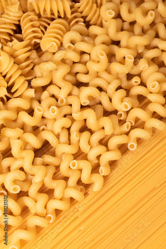 Food background of dry pasta close-up, top view