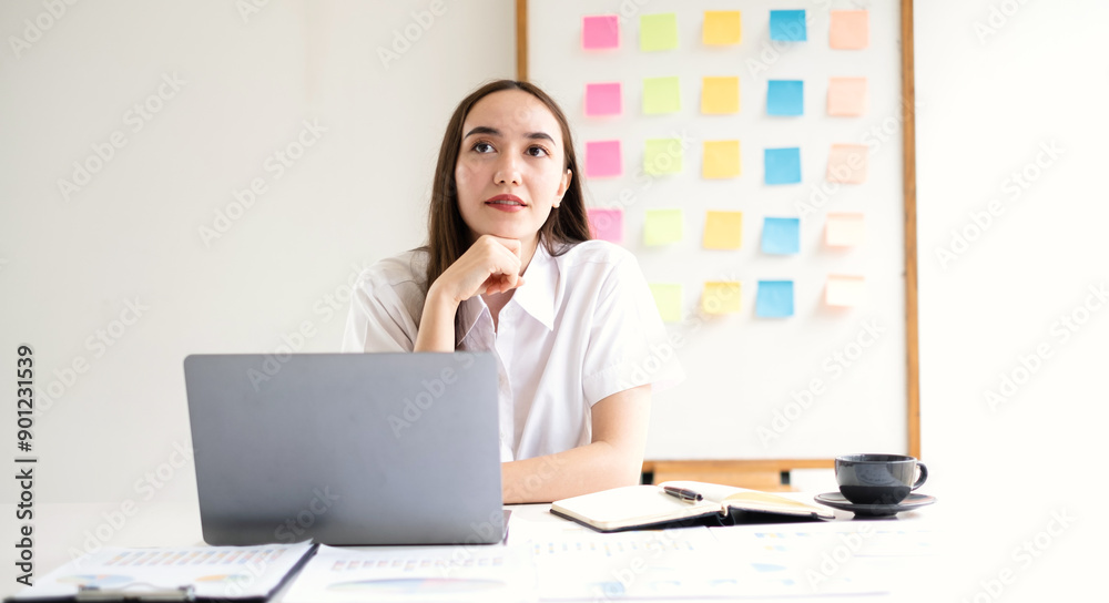 Asian businesswoman calculate financial graphs showing results about their investments, plan a successful business growth process Asian businesswoman calculate financial graphs showing results about their investments, plan a successful business growth process