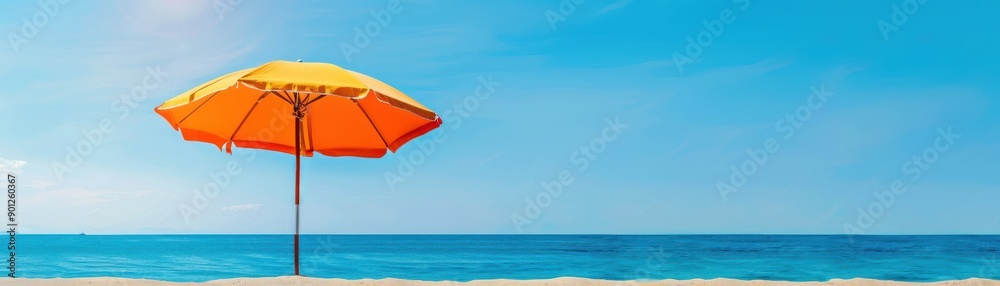 A vibrant orange umbrella stands on a sandy beach, overlooking a serene blue ocean under a clear sky, perfect for relaxation. A vibrant orange umbrella stands on a sandy beach, overlooking a serene blue ocean under a clear sky, perfect for relaxation.