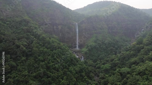 Beautiful mountain rainforest waterfall with fast flowing water at Cikanteh Waterfall Geopark CIiletuh, Sukabumi, Indonesia. Natural seasonal travel outdoor background photo