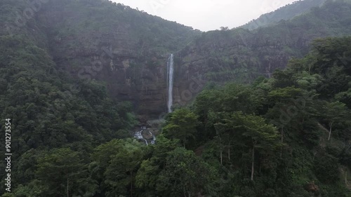 Beautiful mountain rainforest waterfall with fast flowing water at Cikanteh Waterfall Geopark CIiletuh, Sukabumi, Indonesia. Natural seasonal travel outdoor background photo